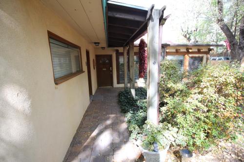 a porch of a house with plants and a building at Dreamcatcher B&B in Taos