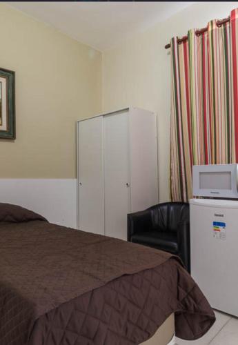 Ένα ή περισσότερα κρεβάτια σε δωμάτιο στο BH EXPO SUITES & KITNETES