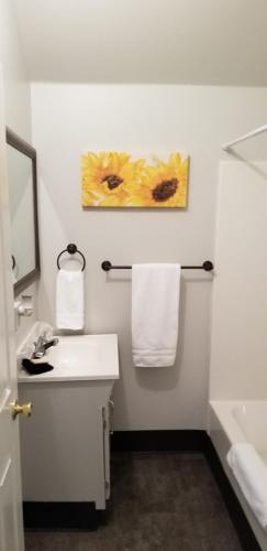 a white bathroom with a sink and a mirror at Deep Water Inn in Chelan