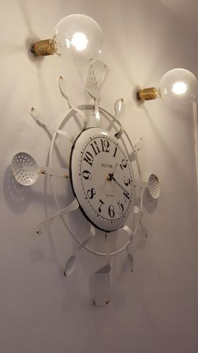 a clock with utensils attached to a wall at Summer Lovers Villa in Akrotiri