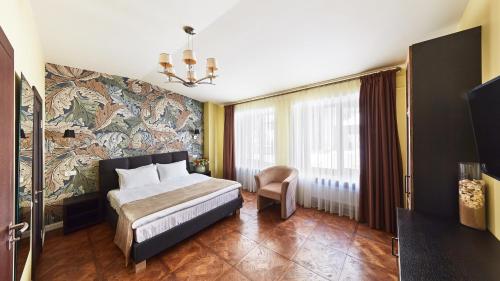 a bedroom with a bed and a large mural on the wall at Shato Luxe in Odesa