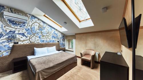 a bedroom with a bed and a tv in a room at Shato Luxe in Odesa