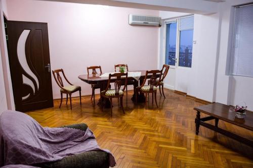 a living room with a dining room table and chairs at City Hall Apartment in Baku