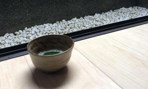 a bowl of water sitting on a table with white balls at Ichijo Premium in Kyoto