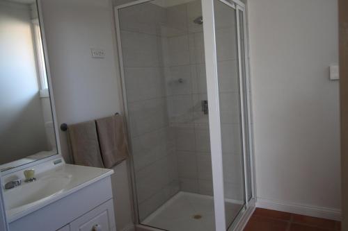 a bathroom with a shower and a sink at Cobram Colonial Motor Inn in Cobram