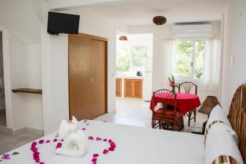 a bedroom with a bed with a flower decoration on it at Villa Lupita in Zihuatanejo