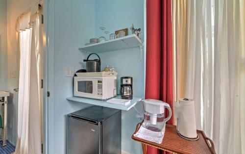 a kitchen with a counter with a microwave and a table at Hale paradise in Keaau