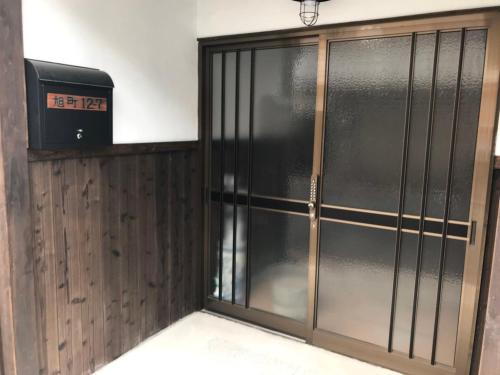 a sliding glass door with a television on top at Private reservation near KIX "Wakeikan" in Izumi-Sano