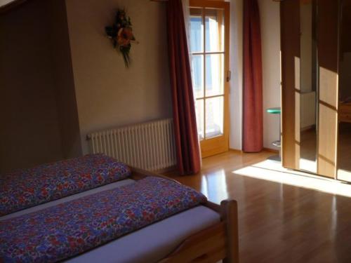 a room with two beds in a room with a window at Appartement Gasser in Anras