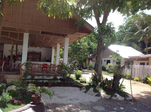 a patio of a house with a tree at Casa Paliton Siquijor near Beach in Siquijor