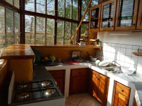 a kitchen with a sink and a stove top oven at NuestraMadreTierra in La Esperanza