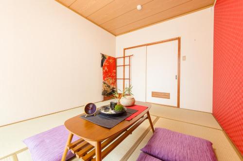 a room with a wooden table and a table sidx sidx at Vacational Rental Sunny Heights in Kanazawa