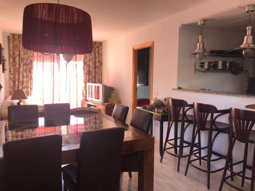 a living room with a dining room table and chairs at Lo Chalet in Les Cases d'Alcanar