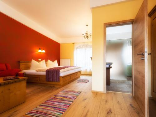 a bedroom with a bed and a living room at Pullman City Westernstadt in Eging