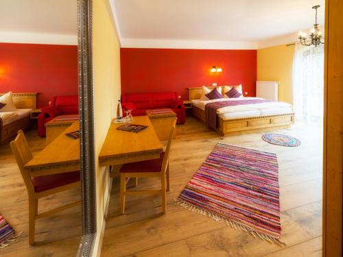a bedroom with a bed and a table and a mirror at Pullman City Westernstadt in Eging