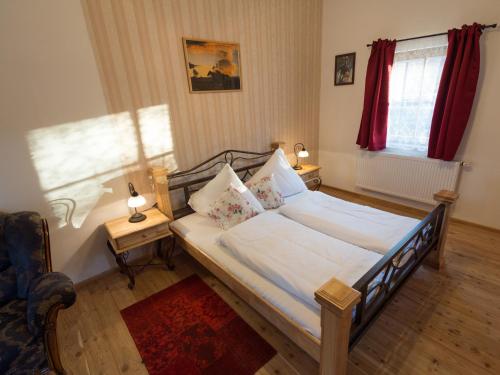 a bedroom with a bed with white sheets and pillows at Pullman City Westernstadt in Eging