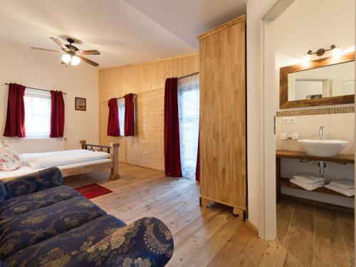 a bedroom with a bed and a sink in a room at Pullman City Westernstadt in Eging