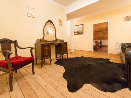 a room with a table and a chair and a mirror at Pullman City Westernstadt in Eging