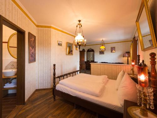 a bedroom with a bed and a sink at Pullman City Westernstadt in Eging