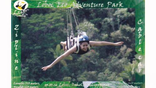 a woman is hanging from a rope in the air at MJ Room Rental in Panglao