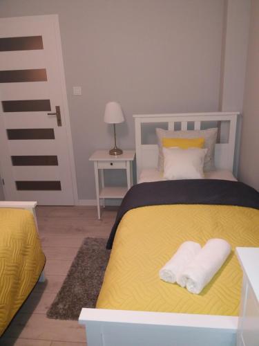 Ένα ή περισσότερα κρεβάτια σε δωμάτιο στο Apartament FAMILY- klimatyzacja