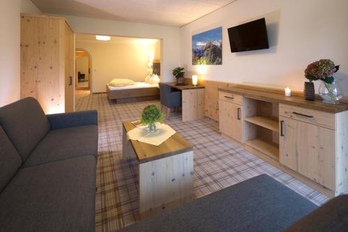 a large living room with a couch and a table at Hotel Bergland in Pertisau