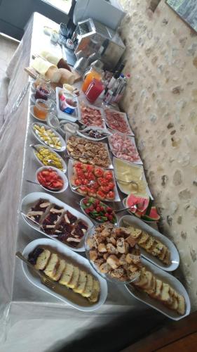 a table with many plates of food on it at Agriturismo Podere Casato in Castelnuovo Berardenga