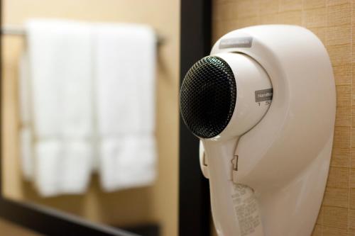 a hair dryer with a microphone on a wall at Celilo Inn in The Dalles