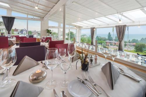 a dining room with a table with wine glasses at Best Western Hotel Rebstock in Rorschacherberg