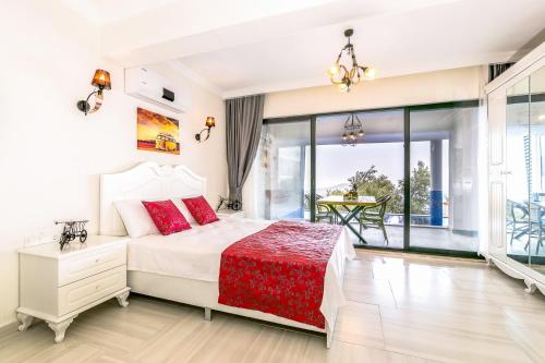 a bedroom with a large bed and a balcony at Villa Spring- Hill Villas Kalkan in Kaş