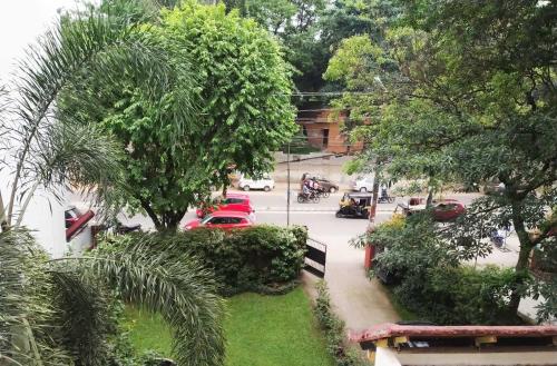 a view of a street with cars and trees at Tagore Homestay Villa Trivandrum in Trivandrum