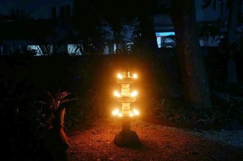 a lighted pillar in the middle of a yard at night at Tagore Homestay Villa Trivandrum in Trivandrum