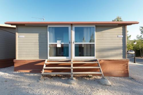 a small house with a staircase in front of it at Camping la Sierrecilla in Humilladero