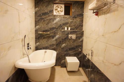 a bathroom with a white toilet and a sink at Nirvana Home in Jodhpur