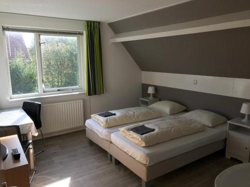 Ένα ή περισσότερα κρεβάτια σε δωμάτιο στο Hofstede Elzenoord