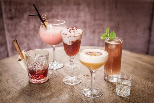 a group of four different drinks on a wooden table at 't Goude Hooft in The Hague