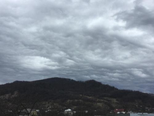 a cloudy sky with a mountain in the background at Girskyi Kut in Kuty
