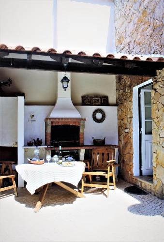 a living room with a table and a fireplace at Casa Rustica do Lagar in Lamas