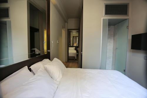 Postel nebo postele na pokoji v ubytování Ferman Pera Hotel