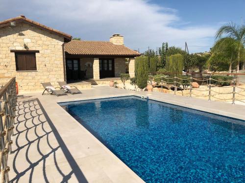 a swimming pool in front of a house at Paradise Traditional House in Maroni