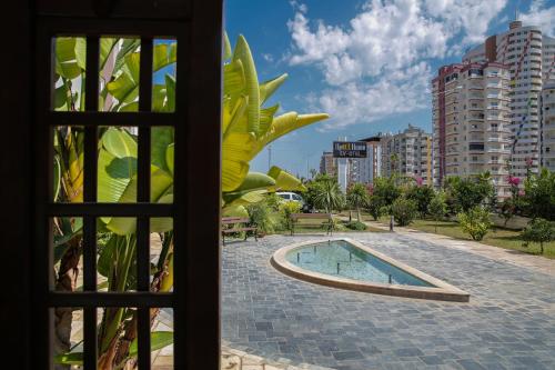 a window view of a swimming pool in a city at Upart Home in Mersin