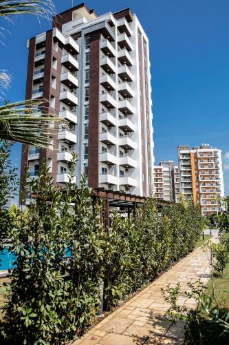 a tall apartment building with trees in front of it at Upart Home in Mersin