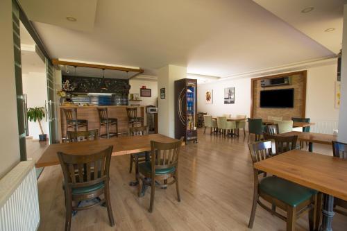 a dining room with wooden tables and chairs at Upart Home in Mersin