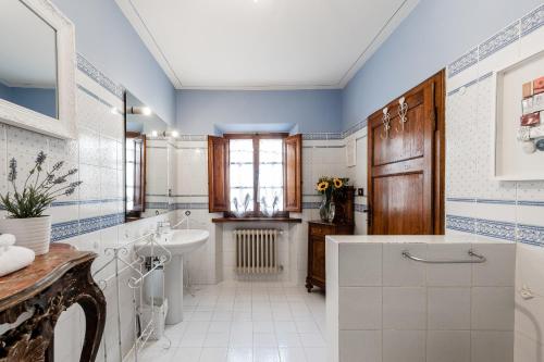 a bathroom with a sink and a toilet at Giardino della Pieve Relais- Adult Only in Cascina