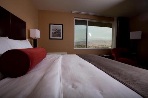 a bedroom with a large bed and a window at Celilo Inn in The Dalles