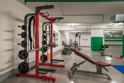 a gym with several treadmills and weights at Trianon Luxury Apartments & Suites in Chania Town