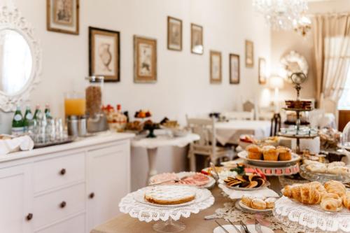 a table with many different types of food on it at Giardino della Pieve Relais- Adult Only in Cascina