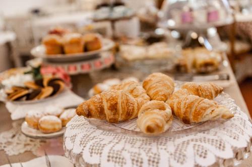 a bunch of croissants and other pastries on a table at Giardino della Pieve Relais- Adult Only in Cascina