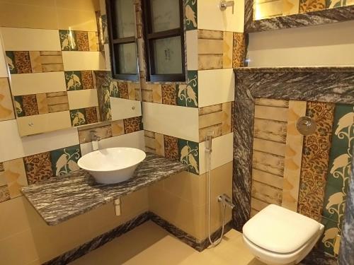 a bathroom with a sink and a toilet at Hotel Varanasi Heritage in Varanasi