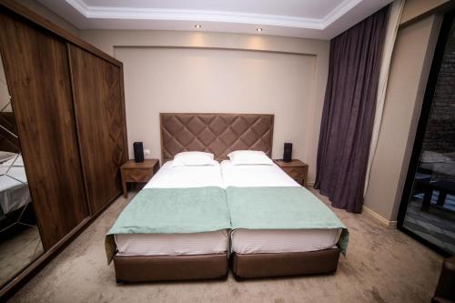 a bedroom with a large bed in a room at Boutique Hotel Mimino in Tbilisi City